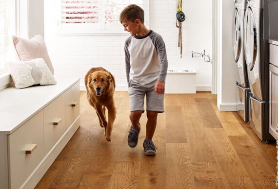 Kid running with dog | Big Bob's Flooring Outlet